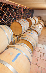 Image showing Wine Barrels and Bottles Age Inside Cellar
