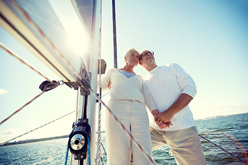 Image showing senior couple hugging on sail boat or yacht in sea