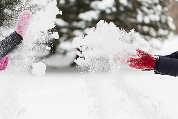 Image showing happy friends playing with snow in winter