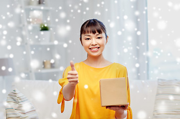 Image showing happy asian young woman with parcel box at home