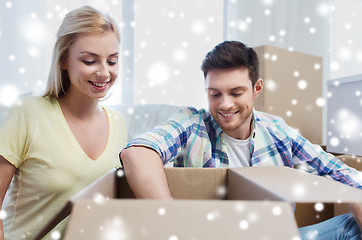 Image showing smiling couple with big boxes moving to new home