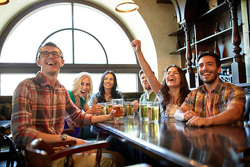 Image showing friends with beer watching football at bar or pub