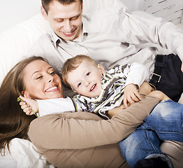 Image showing young happy modern family smiling together at home. lifestyle people concept, father holding baby son
