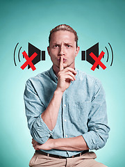 Image showing The serious young man over blue background