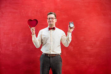 Image showing Young funny man with abstract heart and clock
