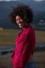 Image showing outdoor portrait of a black woman with a scarf