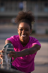 Image showing African American woman doing warming up and stretching
