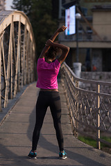 Image showing Black woman doing warming up and stretching