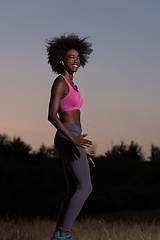 Image showing black woman is doing stretching exercise relaxing and warm up