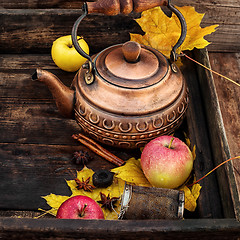 Image showing Copper kettle and autumn leaf fall