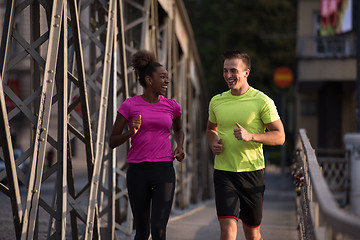 Image showing multiethnic couple jogging in the city