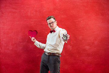 Image showing Young funny man with abstract heart and clock