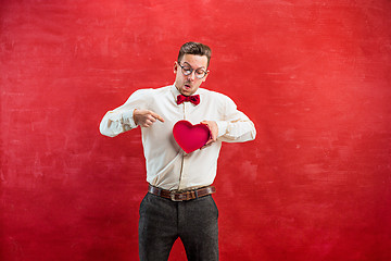 Image showing Young funny man with abstract heart and clock