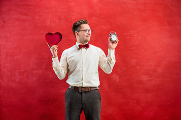 Image showing Young funny man with abstract heart and clock