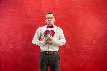 Image showing Young funny man with abstract heart and clock