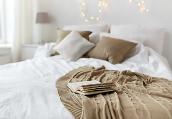 Image showing bedroom with bed and christmas garland at home