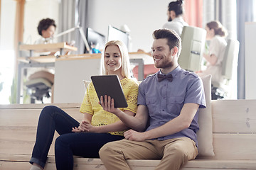 Image showing happy creative team with tablet pc in office