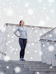 Image showing smiling sportive woman on stairs at city