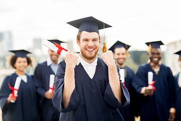 Image showing happy student with diploma celebrating graduation