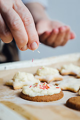 Image showing Person decorating cookies