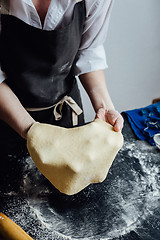 Image showing Person rolling homemade cookie dough