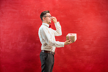 Image showing Young funny man with gift