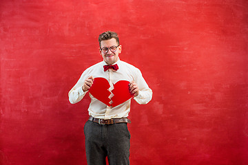 Image showing Young funny man with abstract broken heart