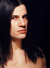 Image showing handsome young man with long hair naked torso on black backgroun