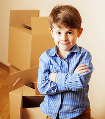 Image showing little cute boy in empty room, remoove to new house. home alone,