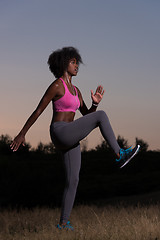 Image showing black woman is doing stretching exercise relaxing and warm up