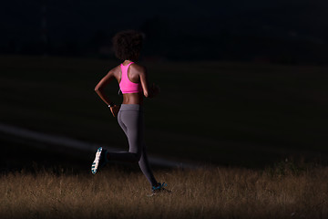 Image showing Young African american woman jogging in nature