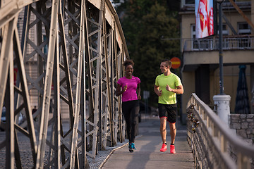 Image showing multiethnic couple jogging in the city