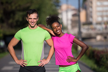 Image showing portrait of young multietnic jogging couple ready to run