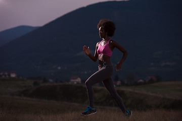 Image showing Young African american woman jogging in nature