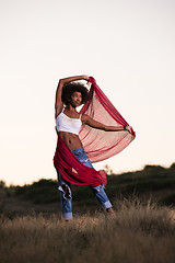 Image showing black girl dances outdoors in a meadow