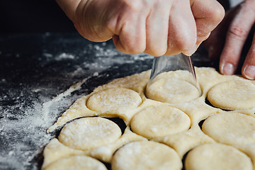 Image showing Person shaping cookies with shot glass