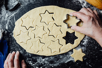 Image showing Cook making star-shaped cookies with form