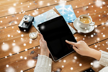 Image showing close up of traveler hands with tablet pc and map