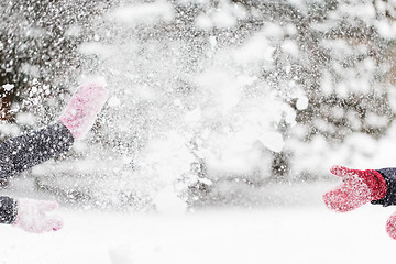 Image showing happy friends playing with snow in winter