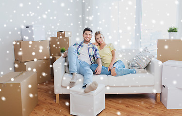 Image showing happy couple with big cardboard boxes at new home