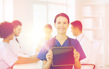 Image showing happy doctor over group of medics at hospital