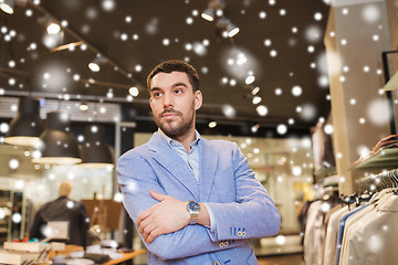 Image showing happy young man in jacket at clothing store