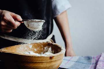 Image showing Person covering pastry with flour