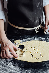 Image showing Person forming star-shaped cookies