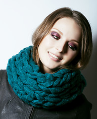 Image showing young pretty real woman in sweater and scarf all over her face s