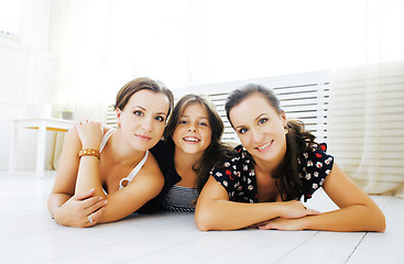 Image showing Mature sisters twins at home with little daughter, happy family 