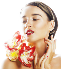 Image showing young pretty brunette woman with red flower amaryllis close up i