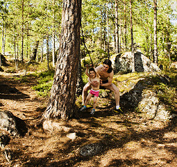 Image showing little cute boy jumping with bungee in forest, training with dad