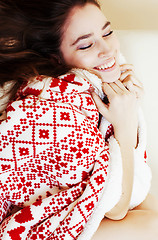 Image showing young pretty brunette girl in Christmas ornament blanket getting