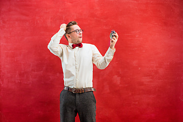 Image showing Young funny man with abstract clock